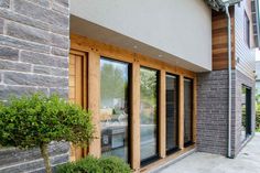 an outside view of a building with wood trimming and glass doors on the windows