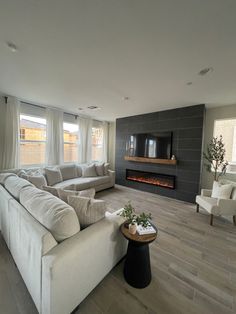 a living room filled with furniture and a fire place in the middle of the room