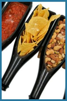 three black serving spoons filled with different types of food and beans on top of each other