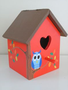 a bird house with an owl painted on it