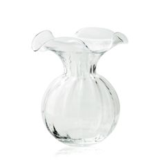 a clear glass vase sitting on top of a white table