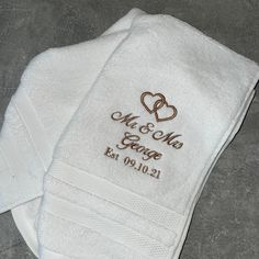 two personalized towels with hearts on them