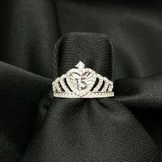 a diamond ring sitting on top of a black cloth