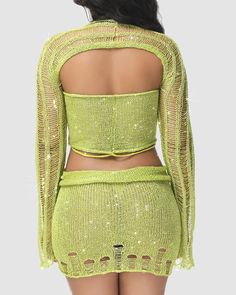 the back of a woman wearing a lime green top and shorts with sheer cutouts