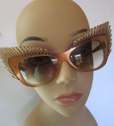 "Stunning Mardi Gras style vintage fantasy eyewear sunglasses. Handcrafted beauties like this are rare and highly collectible, one of a kind, hand painted. Coppery brown frames, carved eyelashes and smoked plastic lens. Art Deco feathers fan out into winged cat eye. Sparklies and clear faceted rhinestones dot eyelashes. Mikli Paris Hand Made in France #029633/ Lens measures 2-1/2\"/6.5cm x 1-1/2\"/4cm , temple 5-1/4\"/13.5cm, total width of glasses 9-1/4\"/23-1/2cm, total height 3\"/7-1/2cm. Con Paris Cat, Winged Cat, Unique Glasses, Boots Shoe, Cat Eye Lash, Jensen Beach, Feather Fan, France Art, Designer Sunglasses