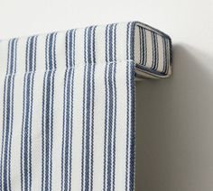 a close up of a blue and white striped pillow