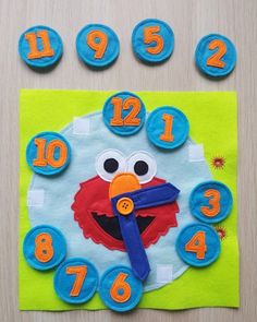 a clock made to look like an elmo face with numbers on the front and sides