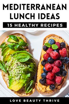 a white plate topped with two pieces of bread covered in fruit and veggies