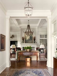 a living room filled with furniture and a chandelier