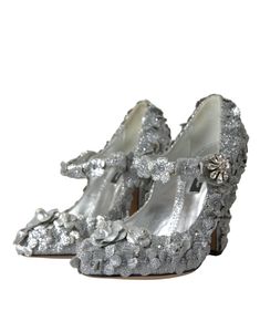 The Dolce & Gabbana Silver Floral Crystal Mary Jane Pumps Shoes are adorned with exquisite silver floral and crystal embellishments. Model: Mary Jane’s pumps Material: 66% Cotton 30% PS 4% Leather Color: Silver Crystal: Clear Leather sole Made in Italy Luxury Embellished Heels For Reception, Silver Heels With Rhinestones For Reception, Luxury Embellished Silver Heels, Luxury Silver Embellished Heels, Luxury Sequined Heels For Wedding, Silver Sequined Heels For Wedding, Silver Glamorous Heels For Reception, Glamorous Silver Heels For Reception, Glamorous Embellished Heels For Galas