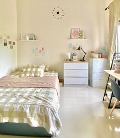 a bed room with a neatly made bed and desk