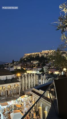 an outdoor restaurant overlooking the city at night