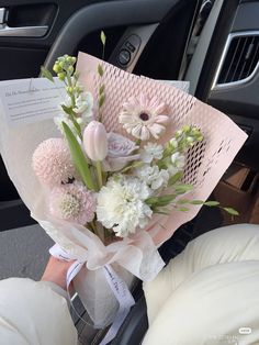 a bouquet of flowers sitting in the back seat of a car