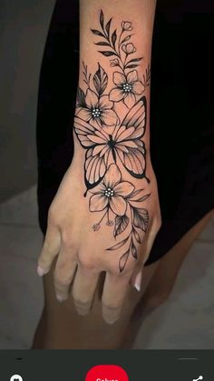 a woman's hand with flowers on it