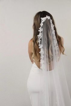 the back of a woman wearing a wedding veil