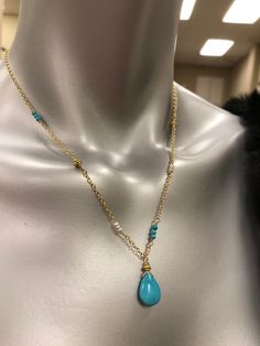 This beautiful necklace is designed with a 10mm X 15mm smooth nugget of Sleeping Beauty Turquoise (that beautiful bright blue color) and wired into a pendant with a Vermeil Bali gold bead. The pendant dangles from sparkly cable chain. Sections of the necklace are accented with tiny (2mm) smooth, round turquoise, Vermeil Bali beads that match the pendant, and tiny (2mm) white freshwater pearls for a unique one of a kind design. The look of Turquoise with gold is a beautiful change to the traditio