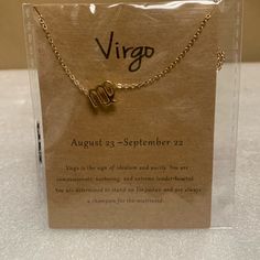 a card with a gold zodiac sign on it and a chain attached to the front