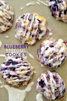 blueberry crumb cookies with white icing on a baking sheet, ready to be eaten