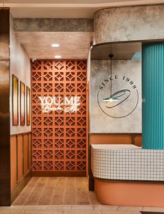 the entrance to a restaurant with an interesting wall design and wood paneling on the walls