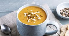 a bowl of soup and some crackers on a table