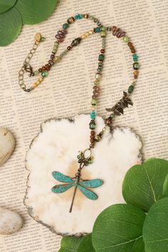 Seasons change, and so do we - the dragonfly has long been a symbol of renewal and change. Hues of green and blues create warmth in this unique handmade collage necklace, finished with a patina dragonfly focal. The perfect addition to your designer jewelry collection. Antique brass (lead- and nickel-free) Czech glass, Turquoise, Freshwater Pearl 20.25-22.25" adjustable length, lobster claw clasp We hand select our natural materials, thus there may be slight variations in color and/or size that w Vintage Handmade Dragonfly Necklace, Handmade Vintage Dragonfly Necklace, Bohemian Green Turquoise Necklace, Handmade Green Dragonfly Jewelry, Handmade Bohemian Dragonfly Necklace, Bohemian Handmade Dragonfly Necklace, Bohemian Green Turquoise Necklace With Patina, Collage Necklace, Floyd Va