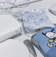 a hello kitty case sitting on top of a desk next to a keyboard and mouse