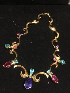 Incredible, vintage 1980's made, pre-owned, Lisa Mele, artist hand made, Hollywood 'Red Carpet' worthy, multi fine gemstone & 18k gold fine art 18" necklace, with tanzanite (blue & purple), rubellite tourmaline (red), apatite (turquoise) & peridot (green), teardrop shaped, & faceted gems... Focal stone is 11/16" x .5" teardrop shaped & faceted, & 1 3/8" long, including apatite stone above Stamped 18k & 14k 707R - This stunning piece is coming from an exciting relationship with a well known & popular Santa Fe, NM, jewelry gallery. I will be listing many exquisite pieces, some at lower prices than they are offered at in the gallery! The owner is a certified Gemologist who has been dealing in fine jewelry from all over the world for almost a half century! Please see my other listings from thi Multicolor Teardrop Gemstone Jewelry, Teardrop Tanzanite Jewelry In Yellow Gold, Luxury Tanzanite Teardrop Jewelry, Tanzanite Teardrop Gemstone Jewelry, Green Tanzanite Multi-stone Jewelry, Hollywood Red Carpet, Tanzanite Jewelry, Rubellite Tourmaline, 18k Gold Necklace