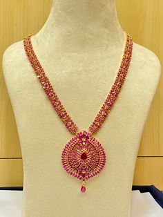 Elevate your style with our Long Handmade Necklace, infused with a touch of Indian elegance. This exquisite piece, measuring 13 inches in length, is available in five different stone options: ruby, emerald, blue sapphire, black, and pearl & coral. Each stone is carefully selected to add a unique charm to your ensemble. Crafted with precision and care by Ray Fine Ornaments Jewellery from India, our necklace boasts meticulous craftsmanship and attention to detail. With 22k yellow gold plating, it Bollywood Ruby Necklaces With Intricate Design, Bollywood Ruby Necklace With Intricate Design, Bollywood Style Ruby Necklace With Intricate Design, Festival Ruby Necklace With Intricate Design, Festive Ruby Necklace With Intricate Design, Elegant Pink Temple Necklace For Festivals, Pink Ruby Necklace For Celebration, Round Necklaces For Receptions And Festivals, Festive Bollywood Ruby Necklace