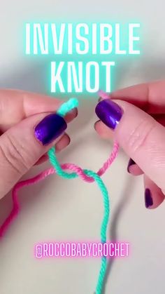 two hands with purple and green nail polish holding a neon colored crochet hook