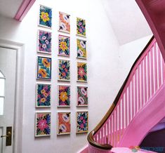 the stairs are painted bright pink and decorated with colorful paintings on the wall above them