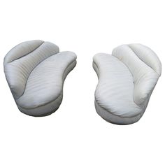 two white couches sitting next to each other