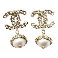 Chanel Gold Chain CC Pearl Dangle Piercing Earrings  * Marked 16 * Made in Italy * Comes with the original box  – Approximately 0.75″ x 1.3″ – Great for any event – In a pristine condition  AB4116-00471  Please see the measurements section for best approximate dimensions. Designer White Metal Jewelry, Luxury Metal Pearl Drop Earrings, Luxury Pearl Drop Metal Earrings, Designer Metal Jewelry With Matching Earrings, Luxury Metal Jewelry With Pearl Drop, Designer Pierced Dangle Jewelry, Designer Gold Drop Pearl Earrings, Designer Gold Pearl Drop Earrings, White Metal Chain Earrings