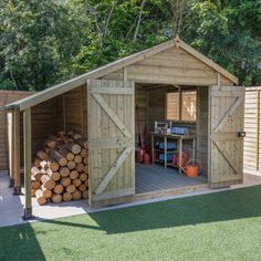 a wooden shed with logs stacked in the front and side doors open to show it's storage area