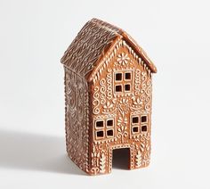 a small wooden house made out of clay