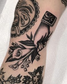 a tattoo on someone's arm that has an owl and flowers in the middle