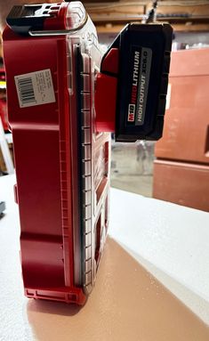 a close up of a red tool box on a table