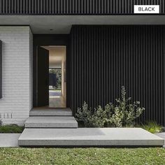 the entrance to a modern home with black and white siding