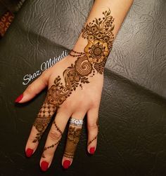 a woman's hand with henna tattoos on it