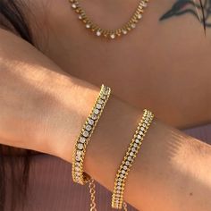 Description: Elevate your style with our exquisite 18k Gold Plated Studded Chain Bracelets Set. Combining elegance and durability, these bracelets are the perfect choice for those who appreciate premium craftsmanship and timeless design. Say goodbye to tarnishing and hello to a versatile accessory that complements any look effortlessly. Each bracelet features a unique 3-layered design, embellished with CZ stones that catch the light beautifully, adding a touch of glamour to your everyday wardrob Elegant Gold Tennis Bracelet With Adjustable Chain, Elegant Round Tennis Bracelet, Tarnish Resistant, Elegant Tarnish Resistant Tennis Bracelet, Tarnish Resistant Cubic Zirconia Chain Bracelet, Elegant Tarnish-resistant Tennis Bracelet, Elegant Adjustable Gold Plated Tennis Bracelet, Elegant Adjustable Gold-plated Tennis Bracelet, Elegant Crystal Chain Bracelet Gift, Elegant Gold Plated Tennis Bracelet, Tarnish Resistant