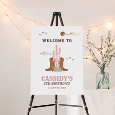 a welcome sign is displayed on an easel