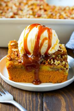 pumpkin dump cake on a plate with ice cream and caramel drizzles