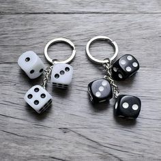 four dice keychains are sitting on a table