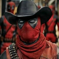 a deadpool man wearing a black hat and red scarf