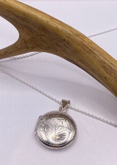 Crafted from 925 sterling silver Measures about an inch (25.5mm) long without the bale, it hangs on a 925 sterling silver chain available in various lengths: 16, 18, 20, 22, or 24 inches.  Inside, the locket offers a tiny sized photo space. For optimum longevity, don't forget to laminate your photo before inserting it. As a veteran-owned, small business, we sincerely appreciate your support.  We provide free shipping within the US and all of our jewelry comes shipped in a stylish gift box. Round Locket, Silver Locket, Photo Locket, Photo Vintage, Silver Lockets, 925 Sterling Silver Chain, Heart Locket, Oval Pendant, Pendant Design