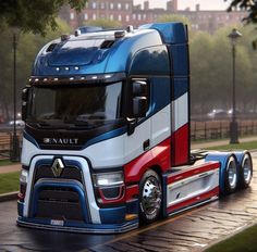 a large semi truck driving down a street next to a park filled with grass and trees