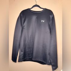 Never Worn And Still In Brand New Condition. The Color Of The Sweatshirt Is A Blue/Grayish Color. Under Armour Crew Neck Top, Under Armour Crew Neck Streetwear Top, Under Armour Crew Neck Top For Streetwear, Casual Crew Neck Top By Under Armour, Sporty Long Sleeve Tops By Under Armour, Under Armour Long Sleeve Winter Tops, Under Armour Long Sleeve Sweatshirt For Sports, Under Armour Long Sleeve Sweatshirt For Streetwear, Under Armour Long Sleeve Sports Sweatshirt