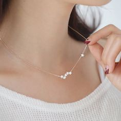 A delicate starburst necklaceGorgeous stars bunched together with one little star following like a constellation in the sky. The little star on the side is double sided with cubic zirconia each side - so even when it's turned around it still shines on your neck. Very delicate and so sweet little necklace. We have matching two-way earrings - please see related product.Brass, cubic zirconia and gold plated, rhodium platedEach star size is about 4m. 43.5mm total length (there is about 2cm extension Shooting Star Necklace, Starburst Necklace, Star Pendant Necklace, Delicate Necklace, Dainty Necklace, Cosmopolitan