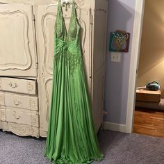 Custom Made Sherri Hill Gown Fits Like A 6/8 Gorgeous Silk Halter Dress Beautiful Beading And Front Detail 100 Percent Silk Dress Wears Gorgeous And Floats Worn One Time In Pageant Embellished Green Maxi Length Evening Dress, Embellished Green Maxi Evening Dress, Elegant Green Embellished Gown, Embellished Green Floor-length Evening Dress, Green Embellished Floor-length Evening Dress, Green Silk Evening Dress For Prom Season, Green Silk Evening Dress For Prom, Fitted Embellished Green Maxi Dress, Green Embellished Maxi Dress For Prom