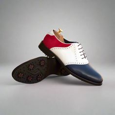 Add eye catching contrast to any outfit with men's saddle shoes! Their distinct two color look is a longtime-favorite for casual and formal styles alike. This versatile footwear gets its name from the saddle-shaped piece that goes across the lace area. The Details: Materials: white box calf + navy painted calf + red kid suede Lining: navy calf leather Sole: GOLF Last: Zurigo - Rounded Toe for Traditional English Look The Fine Print: Shoe production timeline/shipping can vary from 20-30 business White Oxford Leather Shoes With Cap Toe, White Rubber Sole Dress Shoes For Derby, White Cap Toe Oxfords For Derby, White Wingtip Dress Shoes With Rubber Heel Cap, White Dress Shoes With Rubber Sole For Derby, White Oxfords With Rubber Sole For Derby, White Cap Toe Oxfords With Goodyear Welt, White Leather Wingtip Shoes With Rubber Heel Cap, White Oxford Dress Shoes For Derby