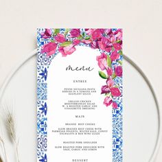 the menu card is decorated with pink flowers and green leaves on a blue floral border